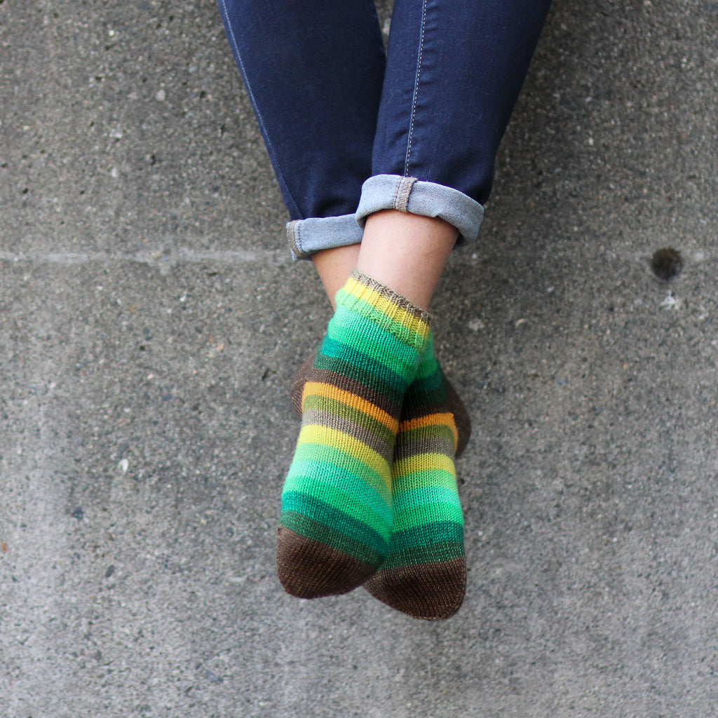 Azurite E green and orange self striping classic sock yarn from gauge dye works