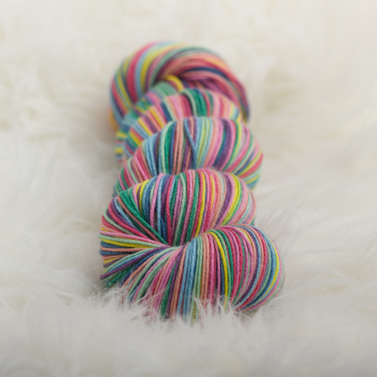 Rainbow White Light self-striping knitting yarn gauge dye works