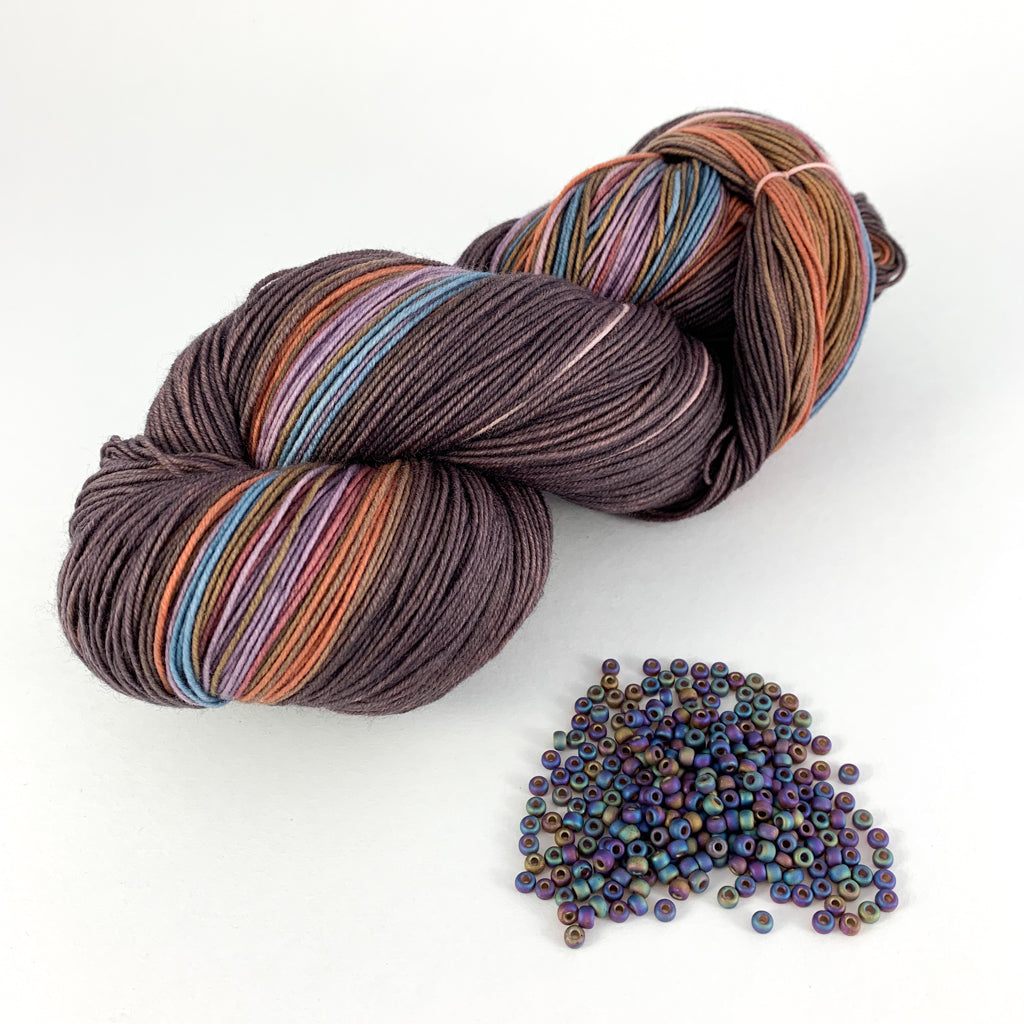  Tesserae self patterning yarn with bead kit by Gauge Dye Works | Flowsaic poncho by Laura Nelkin | striping striped knitting wool beaded beading
